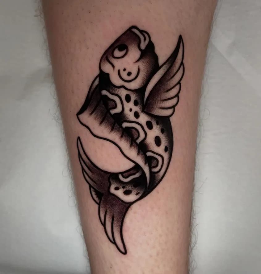 Black and grey traditional koi fish with wings tattoo, on the shin