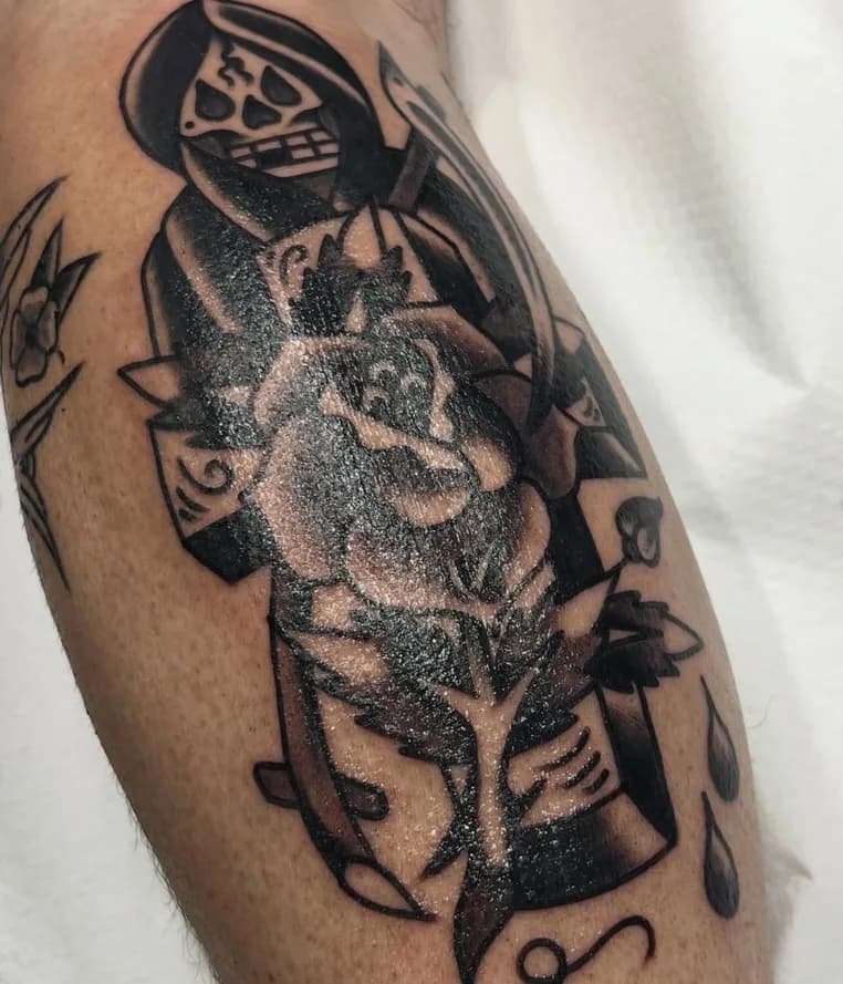 Black and grey traditional grim reaper tattoo with a rose, fresh on the calf
