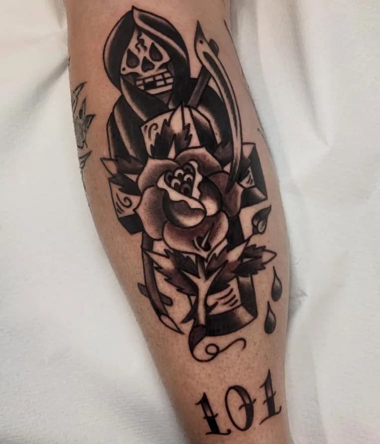Black and grey traditional grim reaper tattoo with a rose, healed on the calf