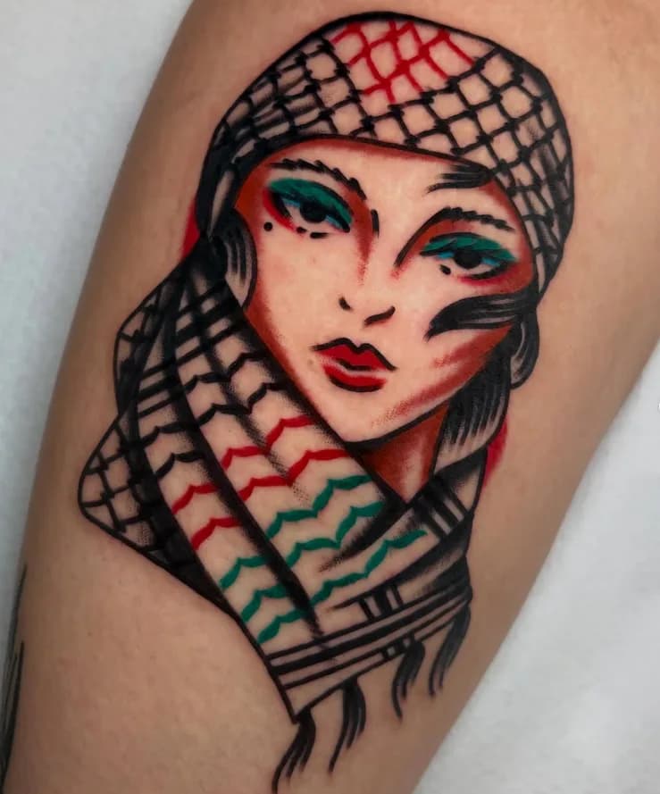 Traditional colorful portrait tattoo of a woman wearing a checkered headscarf, on the forearm