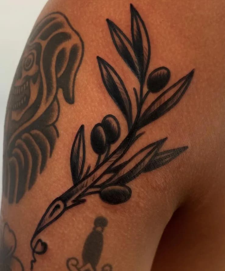 Black traditional olive branch tattoo, on the shoulder