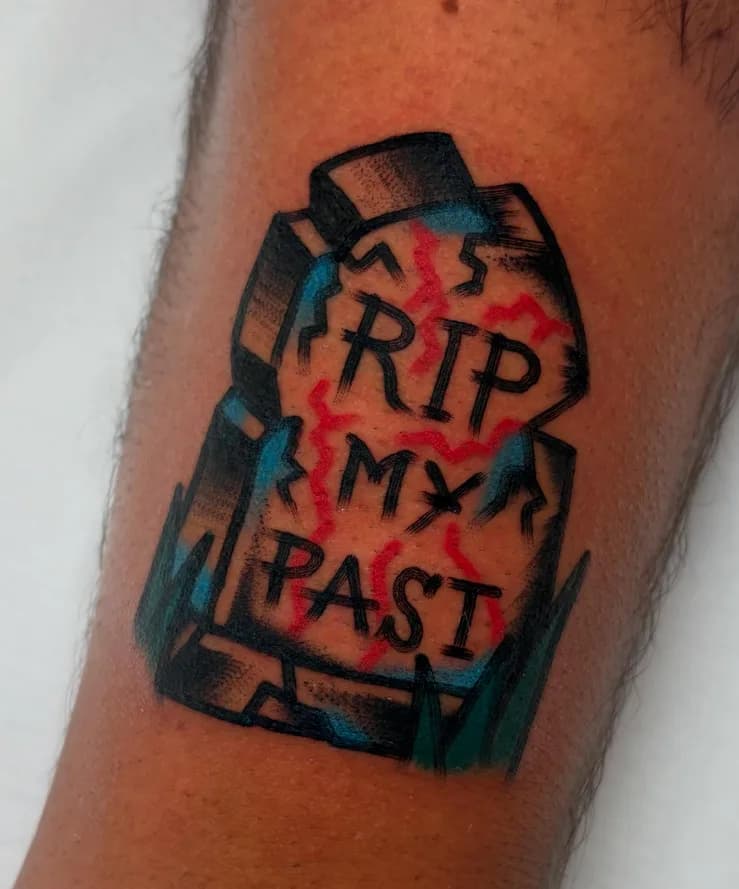 Traditional colorful gravestone tattoo reading 'RIP MY PAST', on the arm